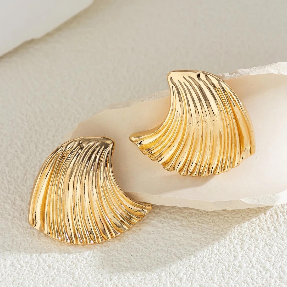 Gold wavy shell drop earrings